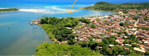 an aerial view of a small island in a body of water at Apartamento com jardím e vista por rio, farol e mar in Itacaré