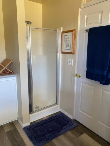 a shower stall in a bathroom with a blue towel at Olympic Trail Retreat in Sequim