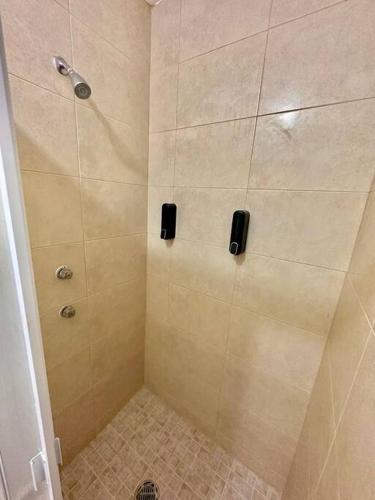 a bathroom with a shower with a tiled floor at Casa con Alberca Privada in Aguascalientes