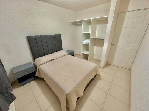 a bedroom with a bed and a white closet at Casa con Alberca Privada in Aguascalientes