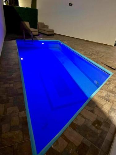 a large blue swimming pool in a room at Casa con Alberca Privada in Aguascalientes