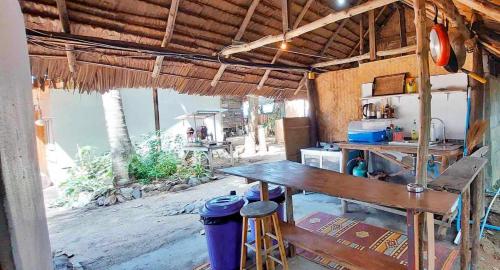 a kitchen with a counter and a table in a building at Little Beach Garden in Ban Ai Dao