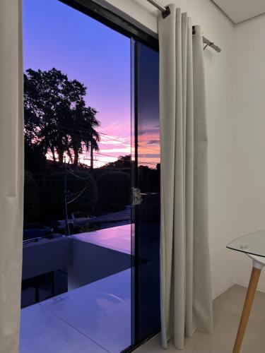 a glass door with a view of the sunset at Habitación en suite in Fernando de la Mora