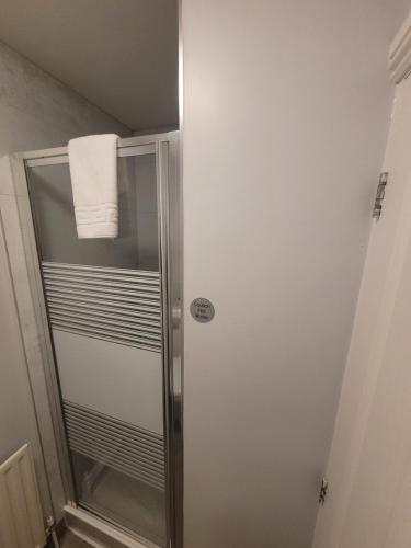 a bathroom with a shower with a towel on it at The Beeches Hotel & Leisure Club in Nottingham