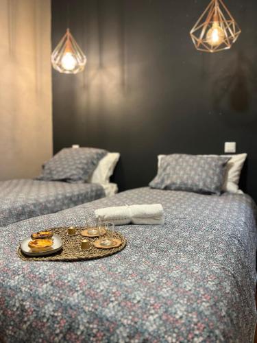a tray of food and glasses on a bed at The Pearl of Lisbon in Lisbon