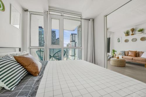 a bedroom with a large bed and a large window at King Bed, Amazing View, Free Parking in Toronto