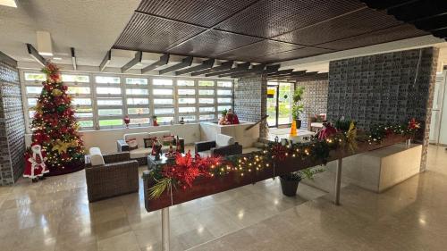 a lobby with a christmas tree in the middle at Beach Front Condo in Isla Verde! in San Juan