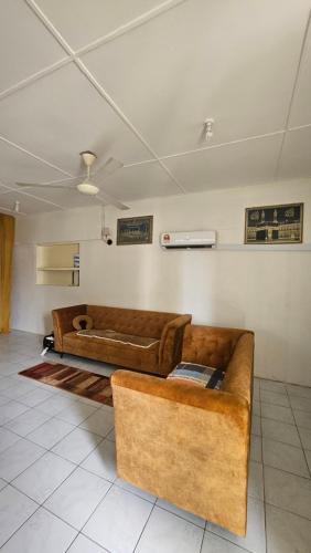 ein Wohnzimmer mit 2 Sofas in einem Zimmer in der Unterkunft Syafeqah Homestay Kimanis Papar in Kimanis
