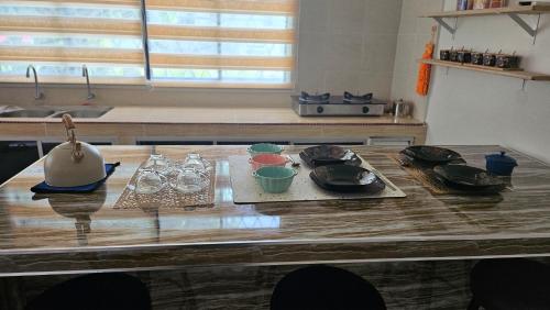 einen Tisch mit Tellern und Schüsseln in der Küche in der Unterkunft Syafeqah Homestay Kimanis Papar in Kimanis