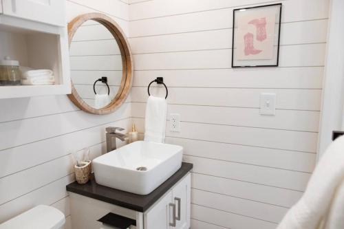a bathroom with a sink and a mirror at New Cowgirl Shipping Container Home in Alpine