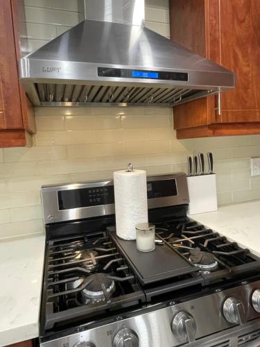a stove top oven with a roll of paper towels at Homestay- private room and bathroom in Whitby