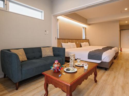 a living room with a couch and a bed at Family Condo Chatan Hills by Coldio Premium in Chatan