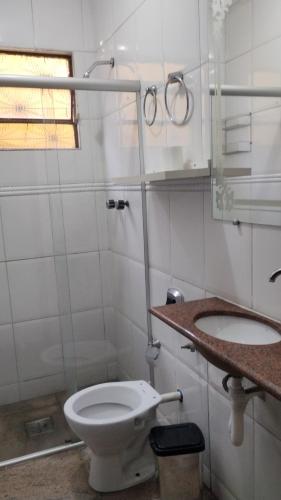 a bathroom with a toilet and a sink at HOSTEL VENDA NOVA in Belo Horizonte