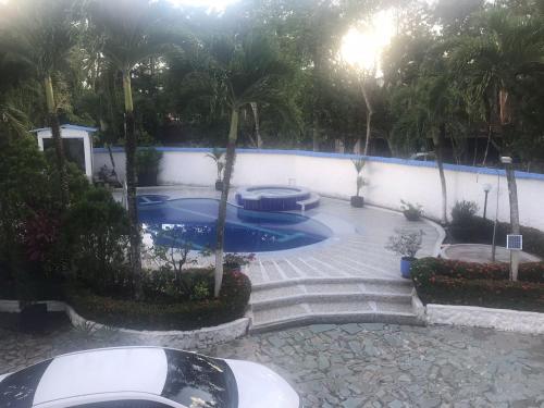 a swimming pool in a backyard with palm trees at Quinta El Diamante in Villavicencio