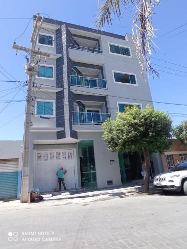 a man standing in front of a building at Hotel Algaroba Anexo in Bom Jesus da Lapa