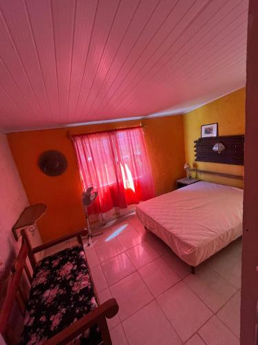 a bedroom with two beds and a pink ceiling at Aguas Dulces in Aguas Dulces