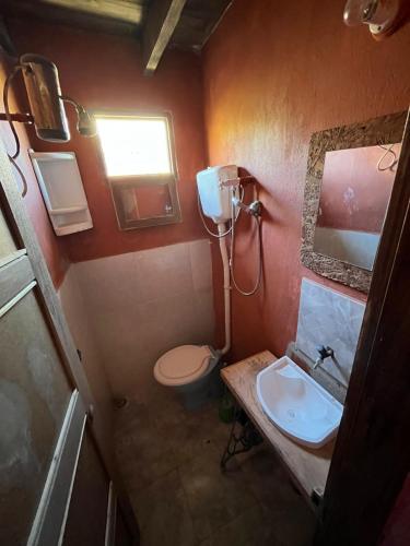 a small bathroom with a toilet and a sink at Aguas Dulces in Aguas Dulces