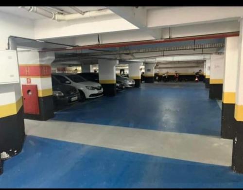 a large parking garage with cars parked in it at Apartamento Flat Palladium in São Vicente