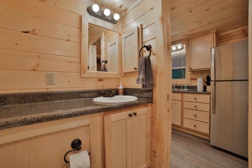 a kitchen with a sink and a refrigerator at Ernie Cabin Wauhatchie Woodlands Tiny Cabin in Chattanooga