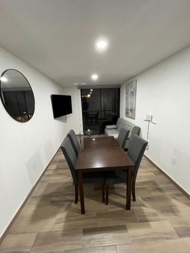 a dining room with a wooden table and chairs at Departamento nuevo a 5 cuadras de Roma Norte in Mexico City
