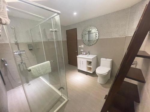 a bathroom with a shower and a toilet and a sink at Baishawan Marina B&B in Shimen