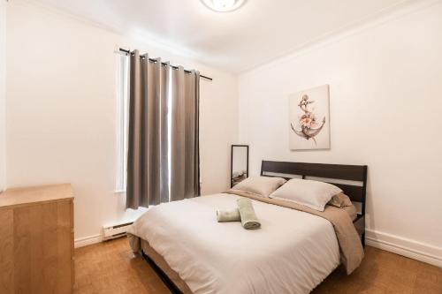 a bedroom with a large bed and a window at 3 bedroom apartment in Verdun in Montreal