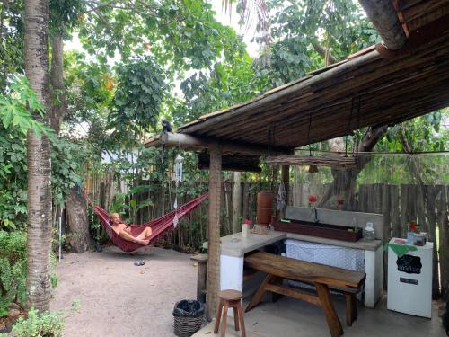 a person sleeping in a hammock in a hammock at Pousada Spa Oasis in Caraíva