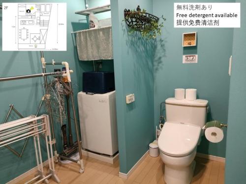 a bathroom with a white toilet and a green wall at Kumamoto - House - Vacation STAY 83489 in Kumamoto