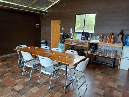 a large wooden table and chairs in a room at Te Ra a Travel Suit Doble Single in Hanga Roa