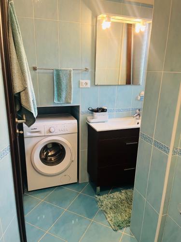 a small bathroom with a washing machine and a sink at Villa Palummo - Stunning Sea View Zambrone, Calabria in Zambrone