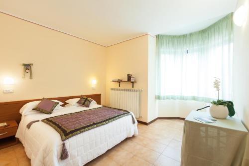 Postel nebo postele na pokoji v ubytování Hotel Fabbrini