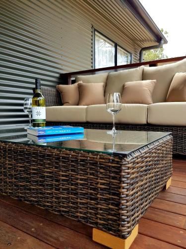 a living room with a couch and a glass table at Quaffers on Storm King in Stanthorpe