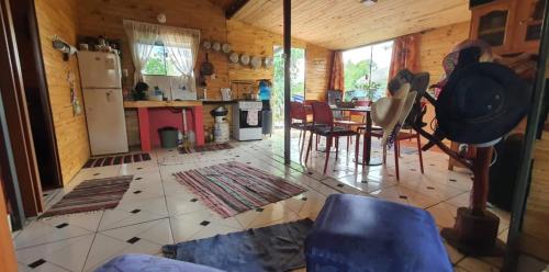 a kitchen and living room with a refrigerator and a table at Pelado Róga in Villa Florida