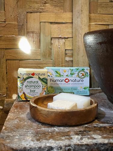 a counter with a bowl of cheese and a container of milk at Tribal Huts Community in Malapascua Island