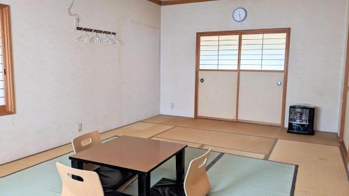 松本市にあるA comfortable Japanese-style condominium limited to one group per day ぎゅーぱんハウスのテーブルと椅子、ドアが備わる部屋