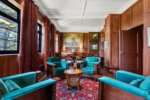 a train car with blue chairs and a table at The Robertson Hotel in Robertson