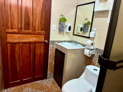 a bathroom with a toilet and a sink at Villas Mapache del Caribe in Puerto Viejo