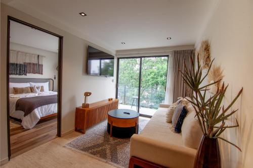 a living room with a couch and a bedroom at Nowness in Mexico City