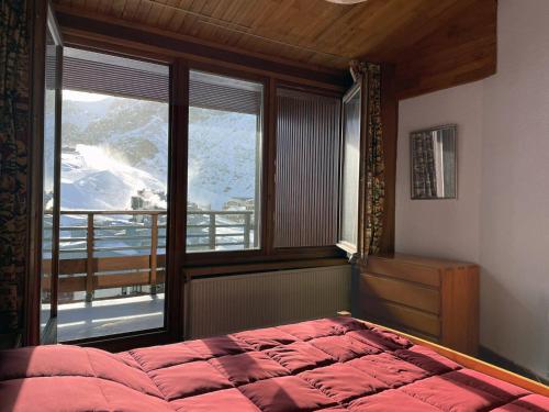 a bedroom with a bed and a large window at 3 pièces au Val Claret avec parking et wifi, proche pistes - FR-1-449-169 in Tignes