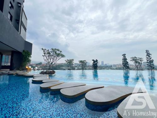 a swimming pool at a hotel with blue water at Arte Cheras Romantic MRT Cheras Wi-Fi Smart Tv AsHome in Kuala Lumpur