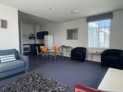 a living room with a couch and a table and chairs at Best Western Wellington in Wellington