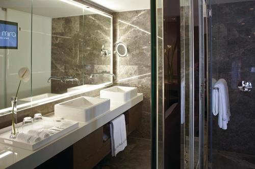 a bathroom with two sinks and a large mirror at The Mira Hong Kong in Hong Kong