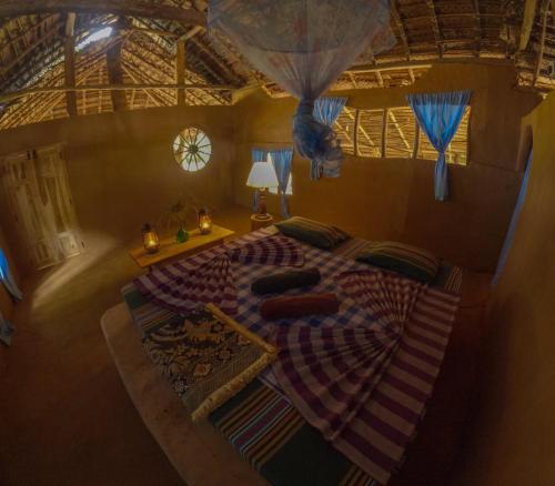 an overhead view of a bed in a room at Glimra eco lodge in Hambegamuwa