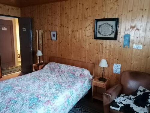 a bedroom with a bed and a chair in it at Chalet La Clusaz, 5 pièces, 6 personnes - FR-1-459-129 in La Clusaz