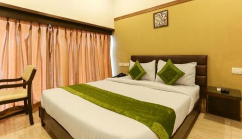 a bedroom with a large bed with a green blanket at $4 HOME STAY (5 MINT WALK FROM GOLDEN TEMPLE) in Amritsar