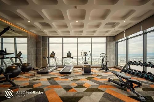 a fitness room with a gym with a view at Mia Apec Mandala Phú Yên in Tuy Hoa