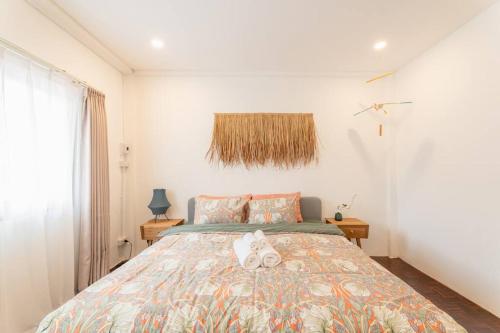 a bedroom with a bed with two stuffed animals on it at Jane house in old city & market in Chiang Mai