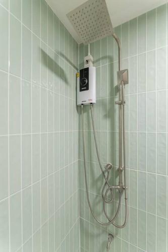 a shower in a tiled bathroom with a shower at Jane house in old city & market in Chiang Mai