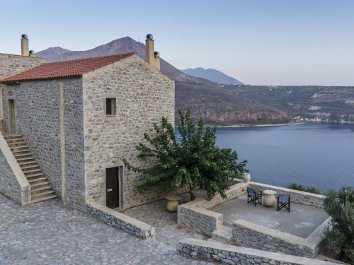 a stone building with a view of a lake at Selana View in Karavostasion