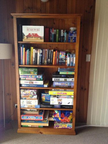 a book shelf full of dvds at The Retreat on Matthew in Batehaven